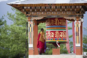 Monks Gallery: A monk and a prayer wheel on the path to the Paro Taktsang monastary in the Himalayan