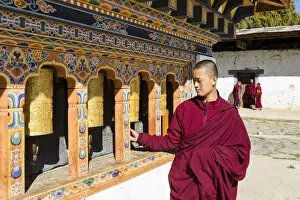 Images Dated 27th May 2020: A monk spinning prayer wheels in Gangteng Monastery, Phobjikha Valley, Bhutan