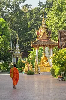 Statues Prints: Monk walking in Wat Sisaket, Vientiane (capital city), Laos