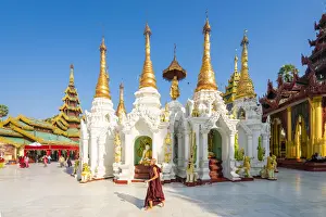 Religious Buildings Prints: Monk walking by White temple in Shwedagon Pagoda complex, Yangon, Yangon Region, Myanmar