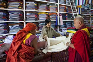 Images Dated 2nd February 2010: Monks buying cloth in a store in Thimphu, Bhutan