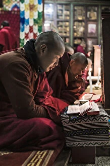 Monks Gallery: Monks during evening candle light prayer in Lhodrak Kharchu monastery, Jakar