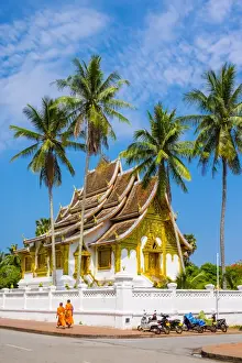Lao Pdr Prints: Monks passing Haw Pha Bang temple on the grounds of the Royal Palace, Luang Prabang