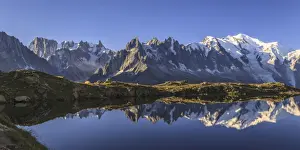 The Mont Blanc mountain range reflected in the waters of Lac de Chesery at sunrise