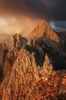 Gold Gallery: The Monte Macina in the Apuan Alps appearing from the clouds on a late autumn sunset. Tuscany, Italy