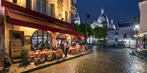 Montmartre at night with illuminated Sacre Coeur Basilica in the background, Paris