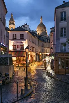 Montmartre at night with illuminated Sacre Coeur Basilica in the background, Paris