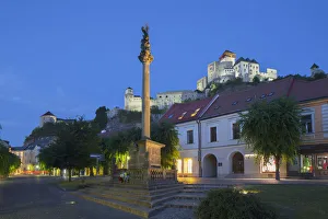Monument in Mierove Square and Trencin Castle at dusk, Trencin, Trencin Region, Slovakia