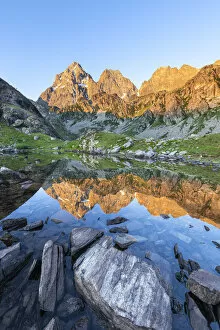 Peaks Gallery: The Monviso Peak reflected in a small alpine lake at sunrise (Fiorenza Lake, Pian del Re
