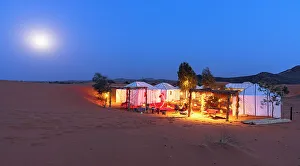 Moonlight Prints: Full moon over berber tents in a desert camp, Erg Chebbi, Merzouga, Sahara Desert, Morocco