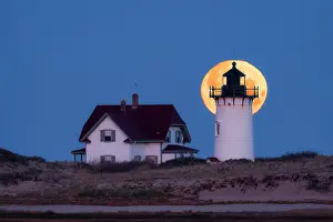 Cape Cod Prints: Full moon setting behind Race Point Lighthouse, Cape Cod, Provincetown, Massachusetts, USA