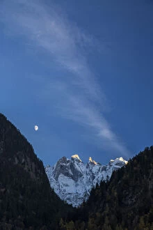 Images Dated 23rd February 2016: The moon on the snowy mountains illuminates the peaks at sunset Bondasca Valley