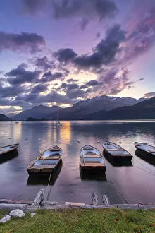 Moored boats in the Lake of Sils at sunrise. Maloja pass, Engadine valley, Graubunden, Switzerland