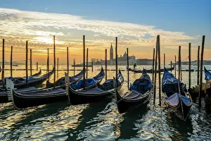 Andrea Palladio Prints: Moored gondolas and Church of San Giorgio Maggiore in the background at sunrise Venice