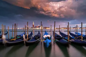 Dramatic Prints: Moored gondolas under a stormy sky at sunset with San Giorgio Maggiore island in the background