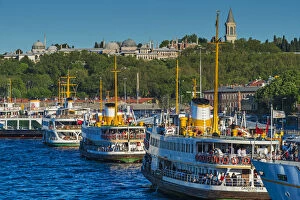 Images Dated 23rd June 2015: Moored passenger ferries at Eminonu quay with Topkapi Palace in the background, Istanbul