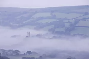 Church Tower Gallery: Morning mist swirls around the church tower of Widecombe in the Moor, Dartmoor, Devon
