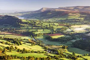 Powys Prints: Morning sunshines illuminates the patchwork fields in the Usk Valley, looking towards