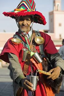 A Moroccan water seller in traditional dress in the Djemaa el Fna
