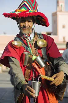 Marrakech Prints: A Moroccan water seller in traditional dress in the Djemaa el Fna