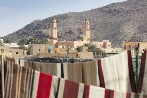 Islamic Architecture Collection: A mosque with carpets hanging in the foreground, Nizwa, Oman