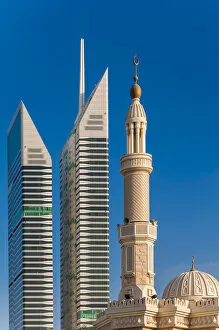 Images Dated 28th February 2014: Mosque minaret with skyscrapers in the background, Dubai, United Arab Emirates