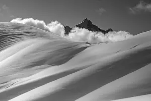 Mount Civetta emerges from the clouds over the slopes of Col Nudo after a heavy snowfall