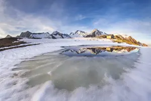Mountain Hut Prints: Mount Disgrazia and Corni Bruciati reflecting in the Lake Meltri in the thawing season