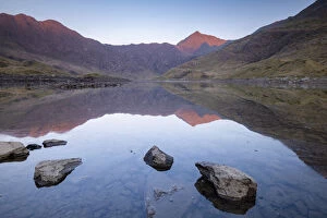 Images Dated 9th June 2020: Mount Snowdon bathed in the first light of dawn and reflected in Llyn Llydaw