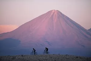 Vulcanism Gallery: Mountain biking in the Atacama Desert against a backdrop