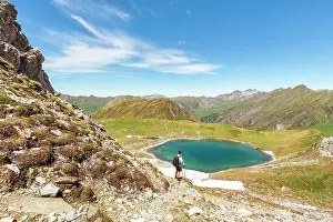 Tiroler Prints: A mountaineer admiring Lake Ramsgrubner and the Tux alps on a summer day