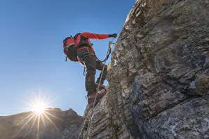 Mountaineer along the via ferrata on the north side of mount Gr. Kinigat, Kartitsch