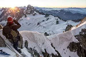 Haute Savoie Gallery: Mountaineer looks at Dent du Geant from Col du Diable at dawn before climbing Arete