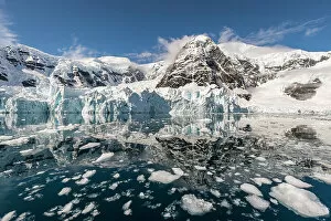Mountains and glacier reflected in the ice strewn sea in Paradise Harbour, Antarctica