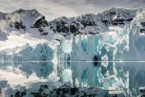 Mountains and glacier reflected in Paradise Harbour, Antarctica