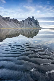 Images Dated 25th February 2016: The mountains reflect on the surface of the ocean. Stokksnes, Eastern Iceland, Europe