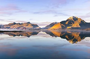 Rorbuer Prints: Mountains and rorbuer reflected in a Fjord during sunset