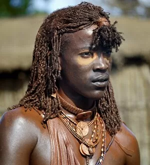 Tribal Attire Gallery: A Msai warrior with his long braids and body coated