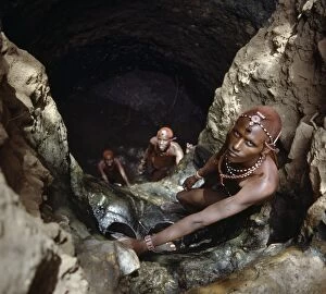 Masai Warrior Collection: Msai warriors draw water from a deep well