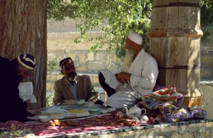 Central Asian Gallery: A mullah sits benath a tree outside the Mausoleum of
