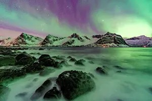 Aurora Borealis Prints: Multicolored Northern Lights sky over snowcapped mountains