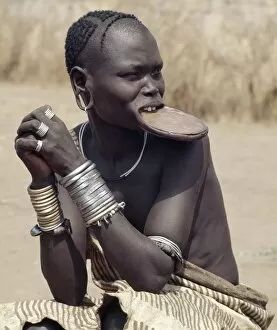 Beaded Necklace Collection: A Mursi woman wearing a large clay lip plate