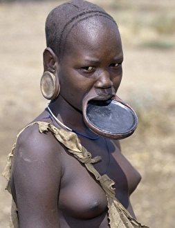 A Mursi woman wearing a large clay lip plate