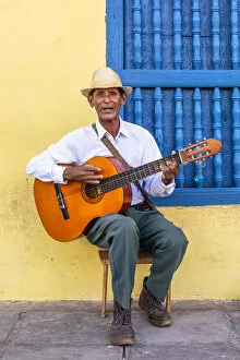 Music Gallery: A musician playing the guitar in Plaza Mayor in Trinidad, Sancti Spiritus, Cuba