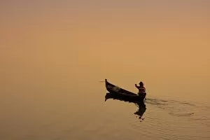 Sun Rise Gallery: Myanmar, Burma, Amarapura. A fisherman paddling across Taungthaman Lake at sunrise