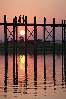 Mandalay Prints: Myanmar, Burma, Mandalay, Amarapura Two monks cross U-Bein bridge at sunset