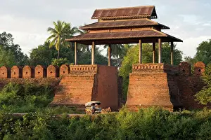 Mandalay Prints: Myanmar, Burma, Mandalay, a carriage passes in front of a brick gate at Inwa