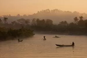Myanmar, Burma, Mrauk U. Early morning mist rising on the Aungdat Creek