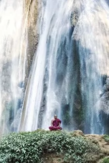 Images Dated 22nd January 2014: Myanmar, Mandalay division, Pyin Oo Lwin. Burmese monk meditating under Dattawgyaik Waterfall