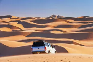 Namib Desert Gallery: Namibia, Walvis Bay, a jeep driving on the san dunes of the Namib desert towards Sandwich Harbour